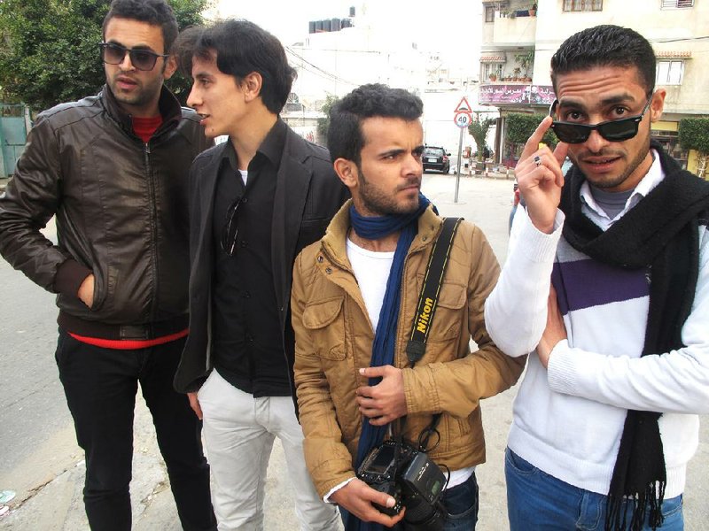 Tashwesh comedy troupe members Mahmoud Zuiter (from left), Ibarhim Khalil, Thaer Munir and Hesham Khattab goof around on the streets of Gaza City in early January. “We live in the kind of place that could use a little humor,” Munir said. 