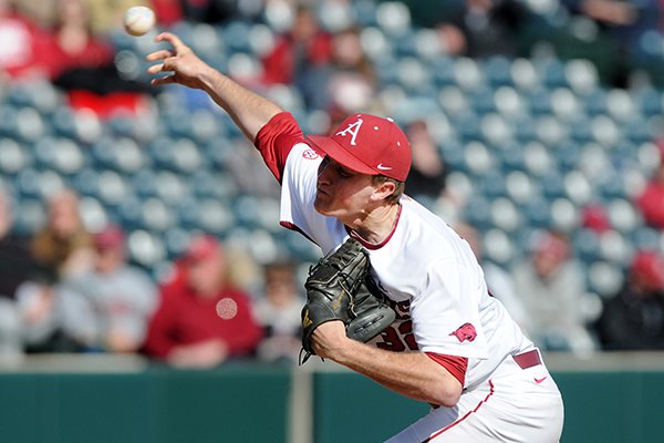 Arkansas' Zach Jackson releases the ball Sunday, Feb. 23, 2014, during the last of a three-game series against Eastern Illinois at Baum Stadium in Fayetteville.