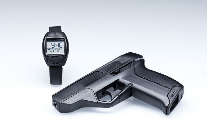 The Armatix iP1 pistol and the iW1 active RFID watch are shown in this photo provided by the manufacturer. The Armatix Smart System consists of a radio-controlled watch that is responsible for gun access and use. A Smart System gun will only shoot if it is within range of the watch. Illustrates GUNS (category a), by Michael S. Rosenwald (c) 2014, The Washington Post. Moved Tuesday, Feb. 18, 2014. (MUST CREDIT: Armatix)
