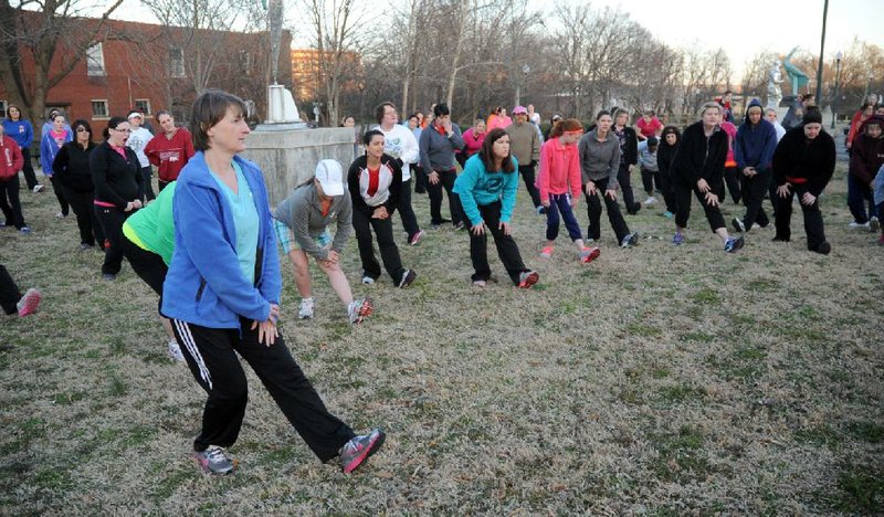 A group of about 85 women learn stretches during the first meeting of the Hot Springs Women Can Run Clinic at Transportation Depot on Tuesday, March 5, 2013. This is the 6th year for the clinic, which is held every spring in conjunction with the Women Can Run 5K in May. The clinic is a 10-week walking/running training program, in which women learn to run a 5K. The group meets every Tuesday and Thursday at 5:45 p.m. at Transportation Depot and free and open to the public. For more information, visit www.womenrunarkansas.net, email, wcrinfo@arspacer.com, or call Shelley Robinson at (501) 538-5680. (The Sentinel-Record/Mara Kuhn)