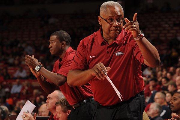 Arkansas associate head coach Melvin Watkins, right, and assistant coach TJ Cleveland, left, direct their team during the second half of play Tuesday, Nov. 5, 2013, in Bud Walton Arena in Fayetteville. 