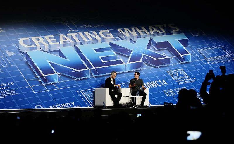 Mark Zuckerberg Chairman and CEO of Facebook, centre right, speaks during a conference at the Mobile World Congress, the world's largest mobile phone trade show in Barcelona, Spain, Monday, Feb. 24, 2014. Expected highlights include major product launches from Samsung and other phone makers, along with a keynote address by Facebook founder and chief executive Mark Zuckerberg. (AP Photo/Manu Fernandez)
