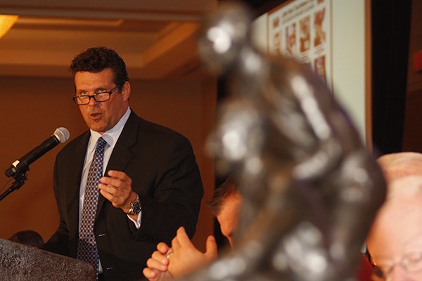 The Broyles Award, given each year to the outstanding assistant coach in college football, sits in the foreground while David Bazzel gives the opening remarks at the first Touchdown Club luncheon of 2013.