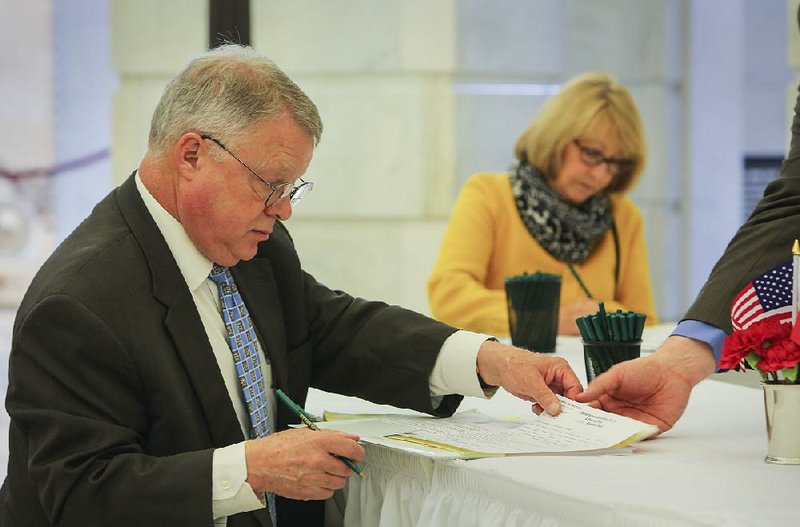 Gordon Webb of Harrison fills out paperwork at the state Capitol on Tuesday. He is running for judge in the 14th Judicial Circuit. 