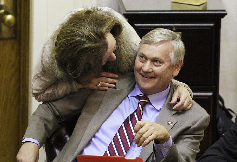 Rep. Jonathan Barnett, R-Siloam Springs, talks with Rep. Karen Hopper, R-Mountain Home, on the House floor Tuesday. A proposal to restrict whom stretches of highways can be named for was defeated Tuesday, and opponents saw it as aimed at Barnett, whose name is on part of U.S. 412. 
