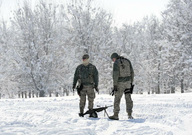 U.S. servicemen keep watch Tuesday at Manas Air Force Base outside Bishkek, Kyrgyzstan. The base has begun closing down as U.S. troops begin using a replacement facility in Romania for moving in and out of Afghanistan. Officials say the longer the United States waits to decide on a future course in Afghanistan, the more costly and risky a withdrawal will become, with more airlifts for a rapid pullout. 