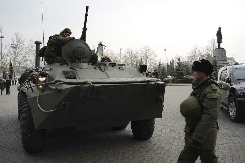 A Russian armored personnel carrier patrols a street Tuesday in Sevastopol, Ukraine’s Black Sea port that hosts a major Russian navy base. Tensions were building up in the Crimea, where ethnic Russians who make the majority of the local population are deeply suspicious of the new Ukrainian authorities who replaced Russian-backed President Viktor Yanukovych. 