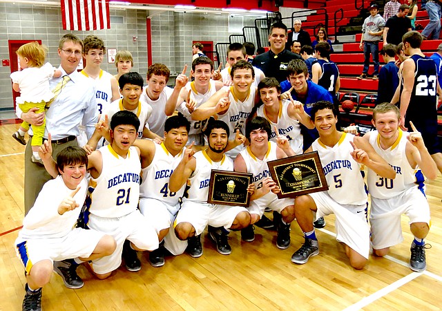 Photo by Mike Eckels The Decatur Bulldog senior boys' basketball team poses with trophies for being 2A 4West runners up and 2A 4 West district champions which they won Feb. 22 during the district tournament in Eureka Springs. The Bulldogs defeated Union Christian 56 to 45 to capture the title. Members include: Joey Barnes (front, left), Pheng Lee, Matt Lee, Allen Castaneda (holding runner-up trophy), Terry Kell, Mario Urquidi (both holding championship trophy), Kyle Shaffer, Coach John Unger and daughter Rose (back, left), Ryan Shaffer, Leng Lee, Bracey Owens (behind Lee) Brody Funk, Trey Kell, Victor Unquidi, Jason Porter (behind Urquidi), Troy Flood, Jason Porter (assistant basketball coach) and Ray Haisman (team manager). For more on the Bulldogs and their games, see Sports on Page 1B.