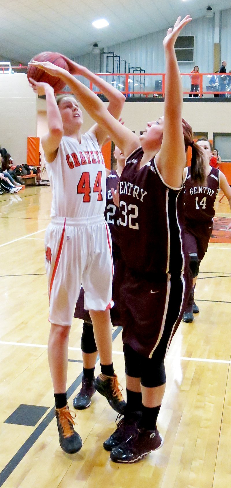 File Photo by Randy Moll Sydney Hicks, Gravette sophomore, attempts a shot while defended by Gentry junior, Meagan Eli, during conference play between the two teams in Gravette.