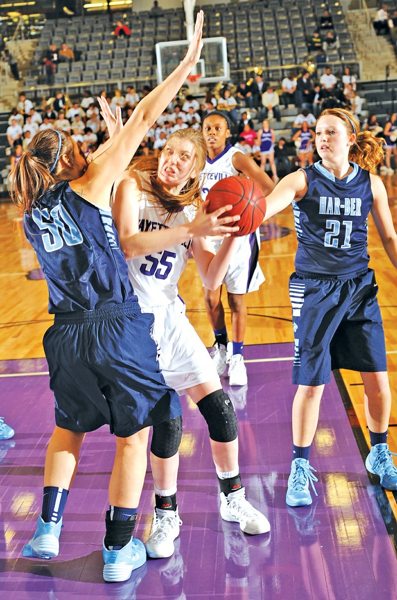 STAFF PHOTO ANDY SHUPE Lauren Schuldt of Fayetteville attempts a shot Tuesday as Springdale Har-Ber's Marleeya Montgomery defends during the first half in Fayetteville.