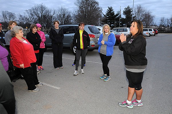 STAFF PHOTO SAMANTHA BAKER 
• @NWASAMANTHA 
Kathryn Wishard, Bentonville/Rogers clinic director, talks to program participants earlier this week at Memorial Park in Bentonville during a pre-meeting for the Woman Can Run/Walk in Bentonville/Rogers. The Bentonville/Rogers clinic begins Monday.
