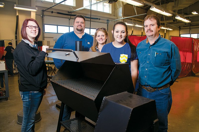 Nikki Glass, from the left, Troy Weatherley, Dusty Baxter, Bethany Farmer and Darren Hawkins are shown with one of the grills that will be auctioned off by Beebe High School FFA students.