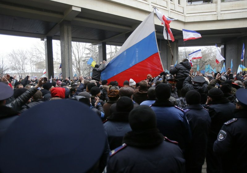 Pro-Russian demonstrators wave Russian flags during a protest in front of a local government building in Simferopol, Crimea, Ukraine, on Wednesday, Feb. 26, 2014. 