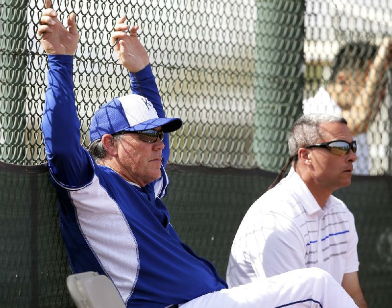 Kansas City Royals Manager Ned Yost (left) and General Manager Dayton Moore watch batting practice earlier this month in Surprise, Ariz. The Royals finished 86-76 last season and are expected to contend in the American League Central this season. Kansas City has not made it to the postseason since 1985, when it won the World Series. 