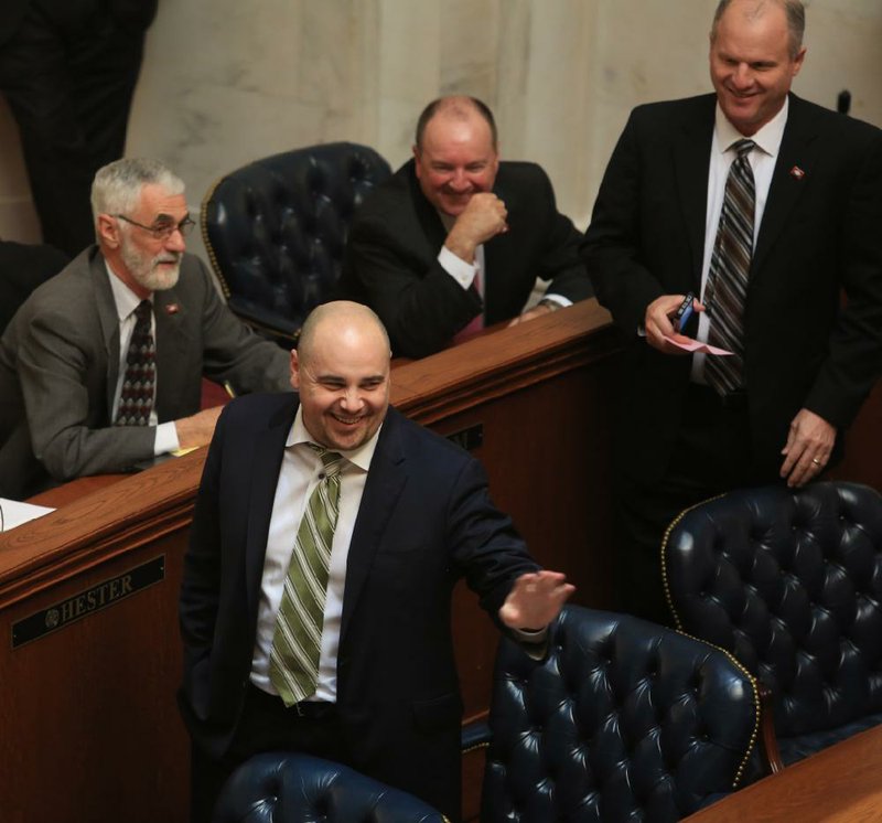 Sen. Jeremy Hutchinson (foreground) jokes Wednesday during a roll-call vote in the Senate that an absent senator had voted for his resolution on armed school guards. 