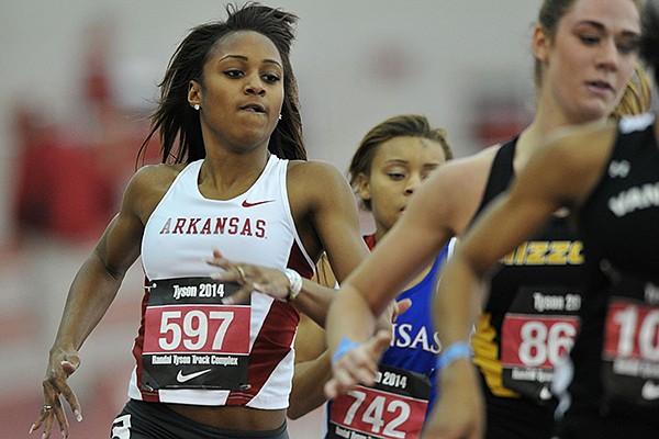 Arkansas runner Brianna Swinton takes the turn as she tries to move up in the pack in the women's 400 meter dash at the Tyson Invitational track meet at the Randal Tyson Track Complex in Fayetteville.