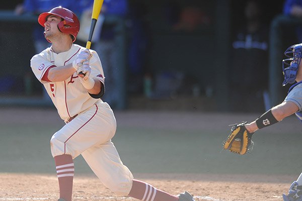 Arkansas shortstop Brett McAfee follows through at the plate during play against Eastern Illinois Friday, Feb. 21, 2014, at Baum Stadium in Fayetteville.