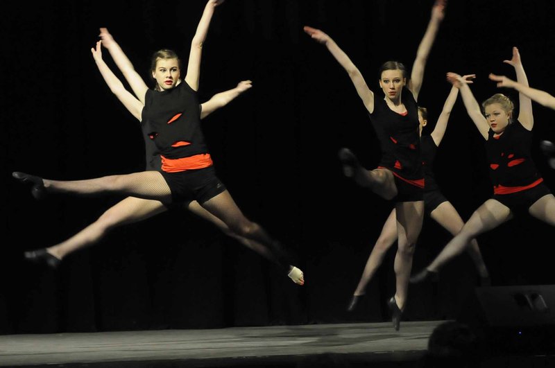 STAFF PHOTO FLIP PUTTHOFF
Dance students from the Benton County School of the Arts high school in Rogers, including Cassidy Baker, from left, Bailey Pile and Lauren Pafford, perform Tuesday during a program for the school's eighth-graders to promote the high school and highlight opportunities offered by the school. The high school orchestra, dance and theater groups were among the performers. Teachers also talked to the eighth-graders about various classes. The program wrapped up with a tour of the school at 506 W. Poplar St.