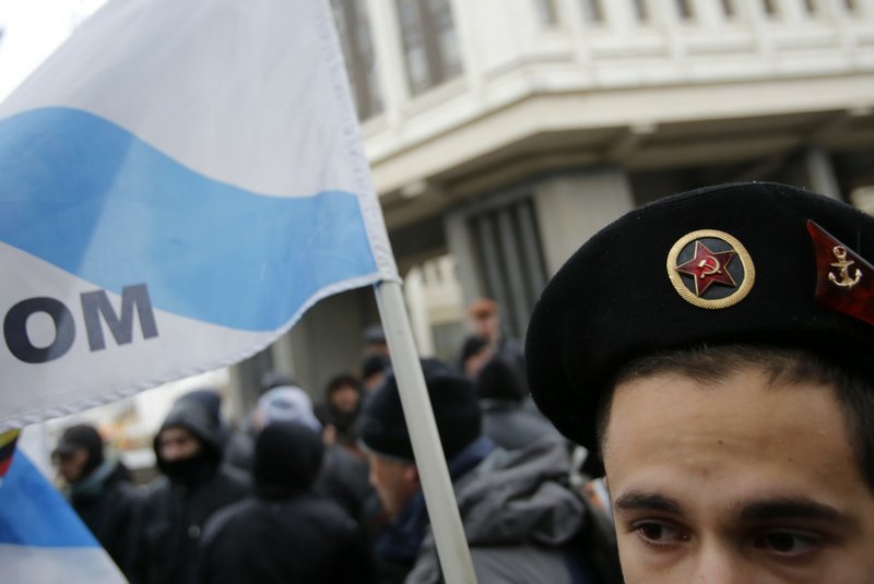 A Pro-Russian demonstrator attends a protest in front of a local government building in Simferopol, Crimea, Ukraine, on Thursday, Feb. 27, 2014. 