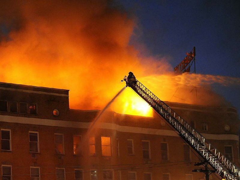 As the Majestic Hotel continued to burn after dark Thursday, fi refighters from Lake Hamilton, 70 West and Middleton volunteer fire departments joined in battling the flames.