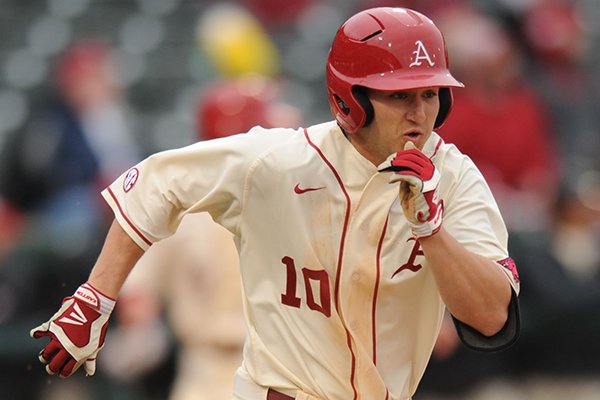 Arkansas left fielder Joe Serrano heads to first after hitting a 3-run double during the third inning against South Alabama Friday, Feb. 28, 2014, at Baum Stadium in Fayetteville.