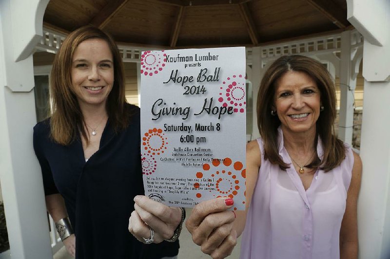 Hope Ball co-chairmen Kori Gordon (left) and Kelly Thompson hold the invitation to the fundraising event for the 20th Century Club’s Lodge, a cost-free “home away from home” for out-of-town patients receiving cancer treatment at local facilities. 