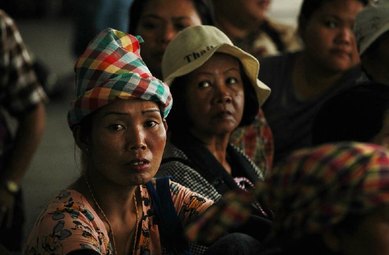 Rice farmers wait to file claim forms for back pay on a rice subsidy plan at the Attorney General's office in Bangkok, Thailand, Friday, Feb. 28, 2014. The rice subsidy program — a flagship policy of Prime Minister Yingluck Shinawtra's administration that helped win the votes of millions of farmers - has accumulated losses of at least $4.4 billion and has been dogged by corruption allegations. Payments to farmers have been delayed by many months. (AP Photo/Wally Santana)