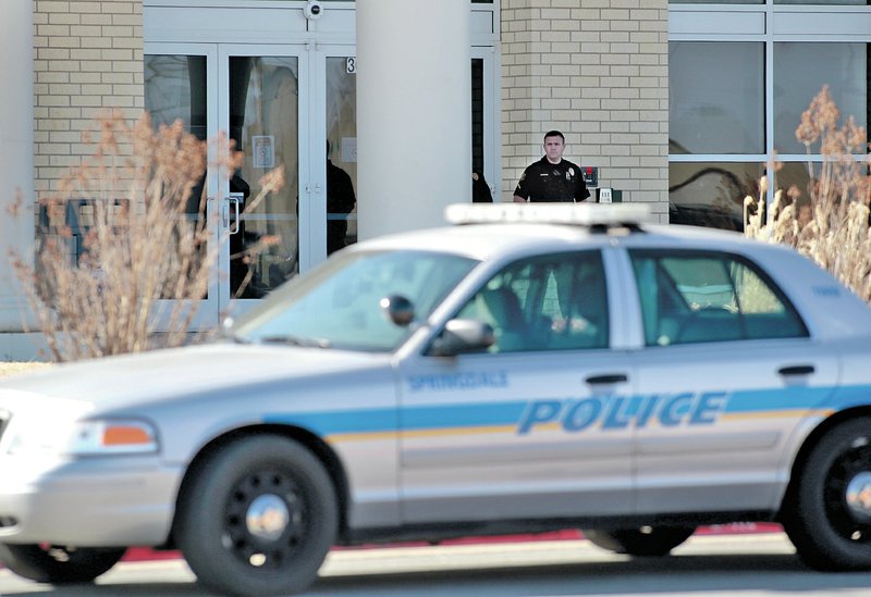 FILE PHOTO JASON IVESTER Springdale Police guard the main entrance Thursday at Har-Ber High School. The school was placed on lockdown after a report of a student with a gun. No weapon was found. A teen girl was charged with misdemeanor disorderly conduct and didn&#8217;t return to class Friday following the incident.