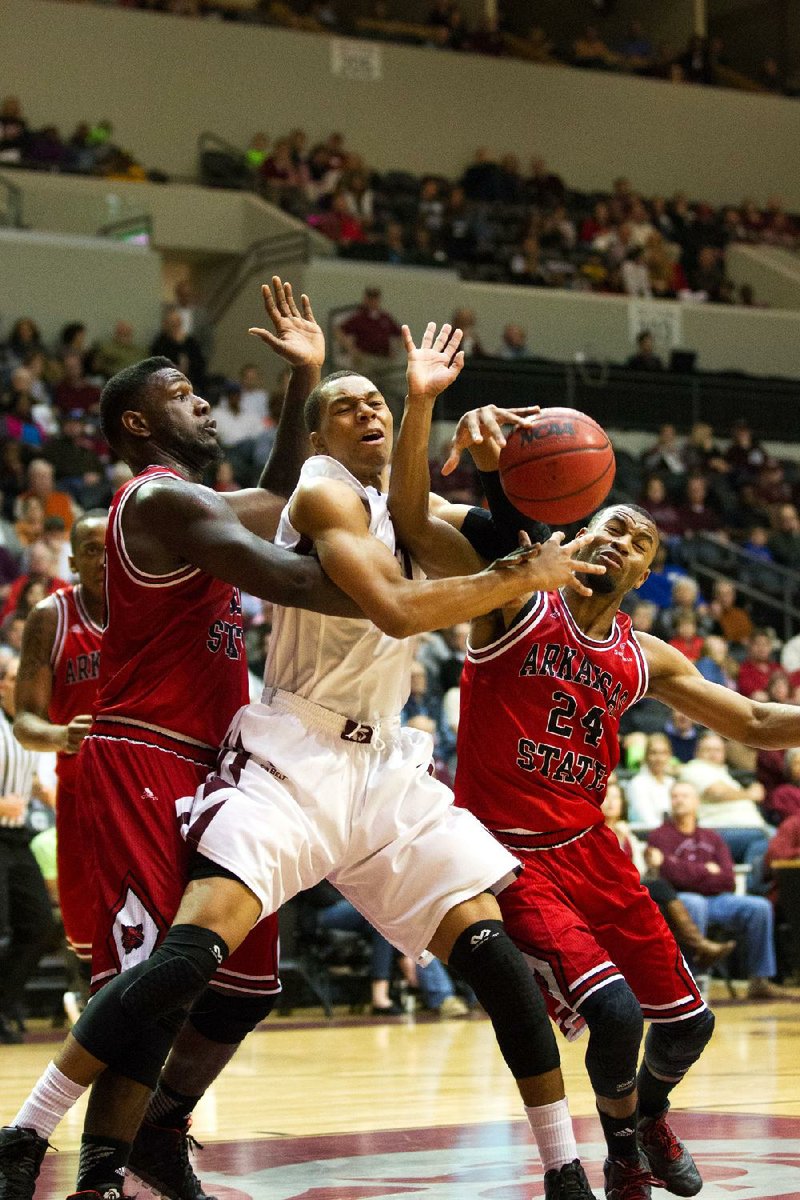 Special to the Arkansas Democrat Gazette/CHRIS BRASHERS - 03/01/2014 - UALR forward Mareik Isom battles a pack of ASU Red Wolves at the Jack Stephens Center in Little Rock, March 1, 2014