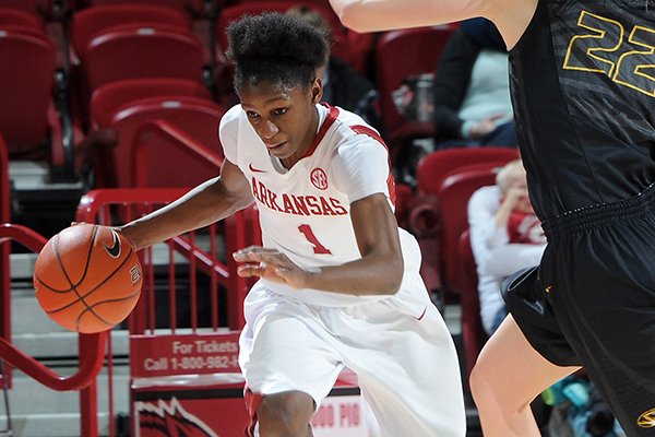 Arkansas' Keira Peak, left, drives down the court as Missouri's Jordan Frericks tries to cut her off Sunday, March 2, 2014, during the second half of the game at Bud Walton Arena in Fayetteville.