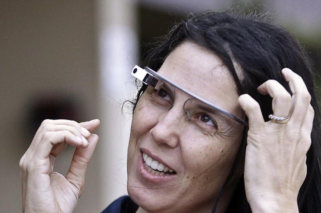 Cecilia Abadie wears her Google Glass as she talks with her attorney outside of traffic court Tuesday, Dec. 3, 2013, in San Diego. When Abadie was pulled over on suspicion of speeding in October, the officer saw she was wearing Google Glass and tacked on a citation usually given to drivers who may be distracted by a video or TV screen. She pleaded not guilty to both charges on Tuesday. (AP Photo/Lenny Ignelzi)