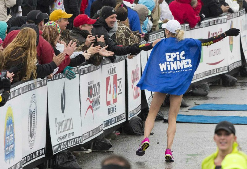 
Arkansas Democrat-Gazette/MELISSA SUE GERRITS 02/28/2014 - Leah Thorvilson greets  bystanders after winning the women's 2014 Little Rock Marathon March, 2, 2014.