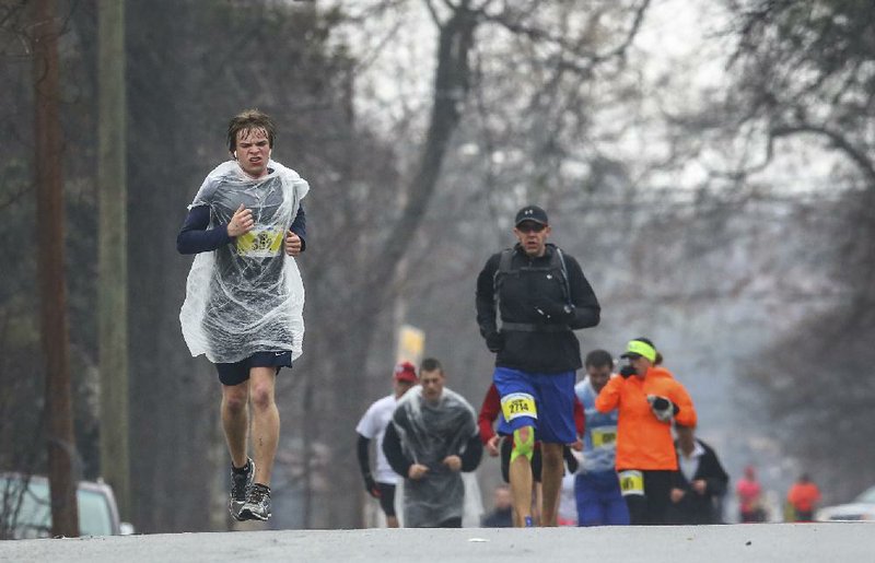 3/2/14
Arkansas Democrat-Gazette/STEPHEN B. THORNTON
Marathon Runner Andrew Binghham, of Little Rock, grimaces in the rain as he runs along 15th Street in Little Rock in the eleventh mile  the 2014 Little Rock Marathon Sunday morning.
