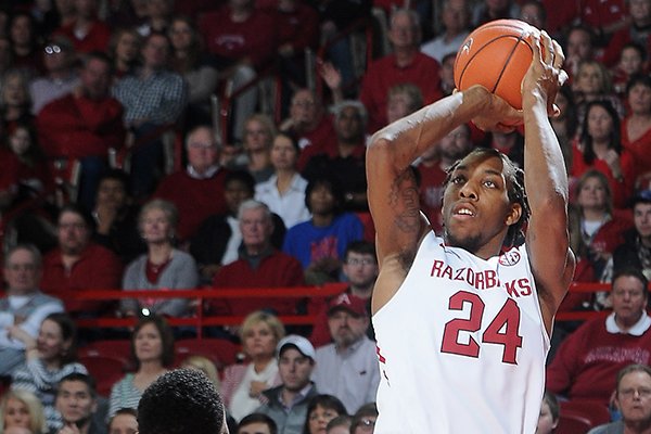 Arkansas' Michael Qualls, right, shoots up and over Marcus Thornton of Georgia Saturday, March 1, 2014, during the first half of the game at Bud Walton Arena in Fayetteville. 