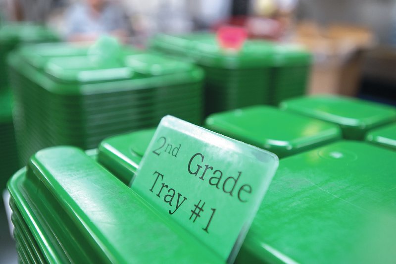STAFF PHOTO ANTHONY REYES Trays are stacked and numbered Thursday at George Elementary School in Springdale. Each grade is numbered for students to keep the correct amount of food prepared for lunch.