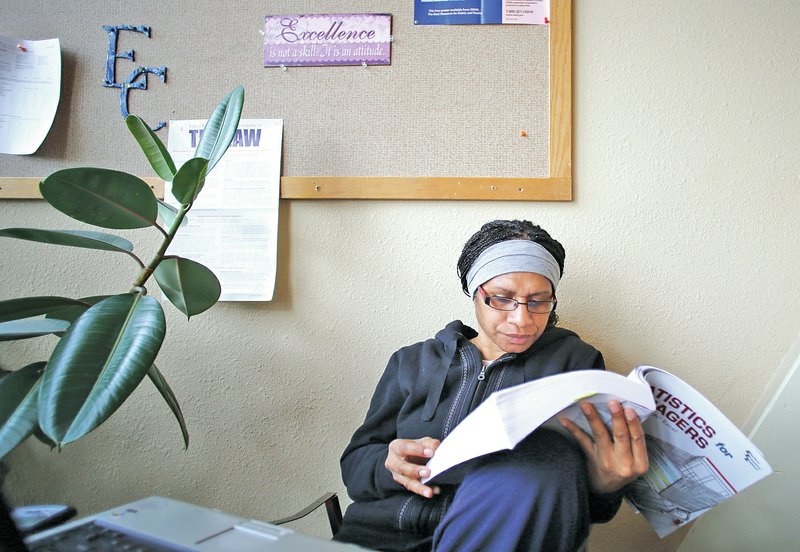 STAFF PHOTO DAVID GOTTSCHALK 
Elizabeth Humbu of Papua, New Guinea, studies data analysis between classes at Ecclesia College on Feb. 19 on campus.