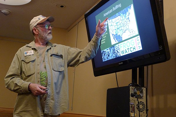 Arkansas Democrat-Gazette/BILL BOWDEN 
Tom Krohn, Arkansas regional coordinator for FrogWatch USA, talks about bullfrogs at a meeting last week at the Boone County Library in Harrison. Krohn is trying to save the state’s frog and toad populations by offering sessions on amphibian calls.