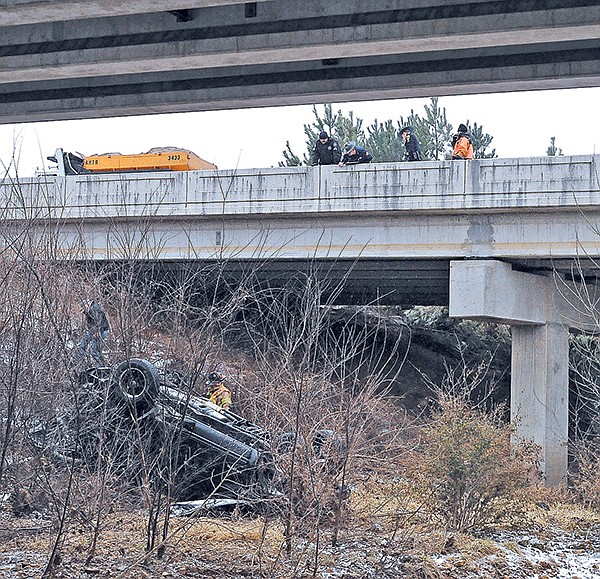 STAFF PHOTO BEN GOFF 
Arkansas State Police and Rogers Fire Department personnel look over the scene of a fatal crash Sunday on Interstate 540 north of Exit 81 in Rogers.