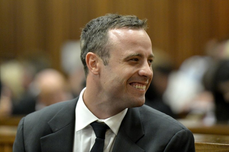 Oscar Pistorius smiles in court during his trial at the high court in Pretoria, South Africa, on Monday, March 3, 2014. Pistorius is charged with murder with premeditation in the shooting death of girlfriend Reeva Steenkamp in the predawn hours of Valentine's Day 2013. 