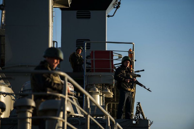 Ukrainian seamen stand guard on the Ukrainian navy ship Slavutich at harbor of  Sevastopol, Ukraine, Monday, March 3, 2014. The Ukrainian Defense Ministry said that Russian forces that have overtaken Ukraine's strategic region of Crimea are demanding that the ship's crew surrender.  (AP Photo/Andrew Lubimov)