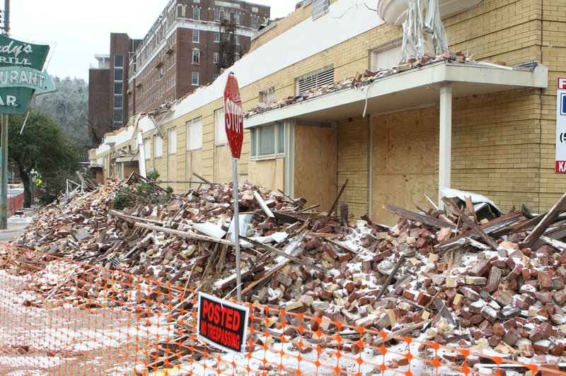 Bricks and debris from the Majestic Hotel cover the sidewalk along Park Avenue in Hot Springs on Monday, March 3, 2014. 