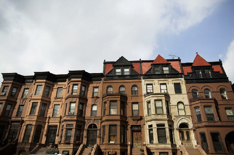A row of brownstone homes line a street in the Brooklyn borough of New York last month. Real estate data provider CoreLogic said Tuesday that U.S. home prices rose 0.9 percent in January. 