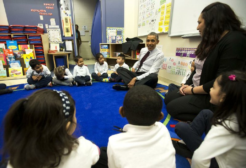President Barack Obama joins teacher Graciela Segovia and her preschool class Tuesday during circle time at Powell Elementary School in Washington, D.C. Obama sent a $3.9 trillion budget request Tuesday that included increased spending for education, among other areas. 