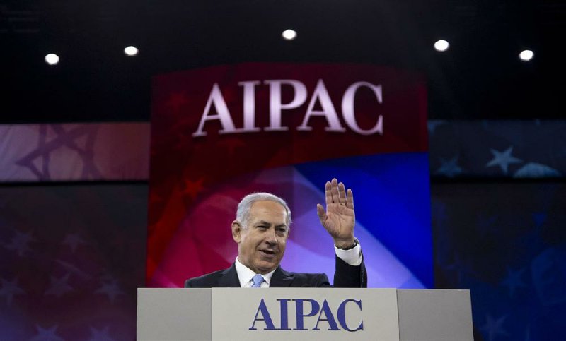 Israeli Prime Minister Benjamin Netanyahu waves to the cheering audience as he arrives to speak to the American Israel Public Affairs Committee’s annual policy conference Tuesday at the Washington Convention Center in Washington. 