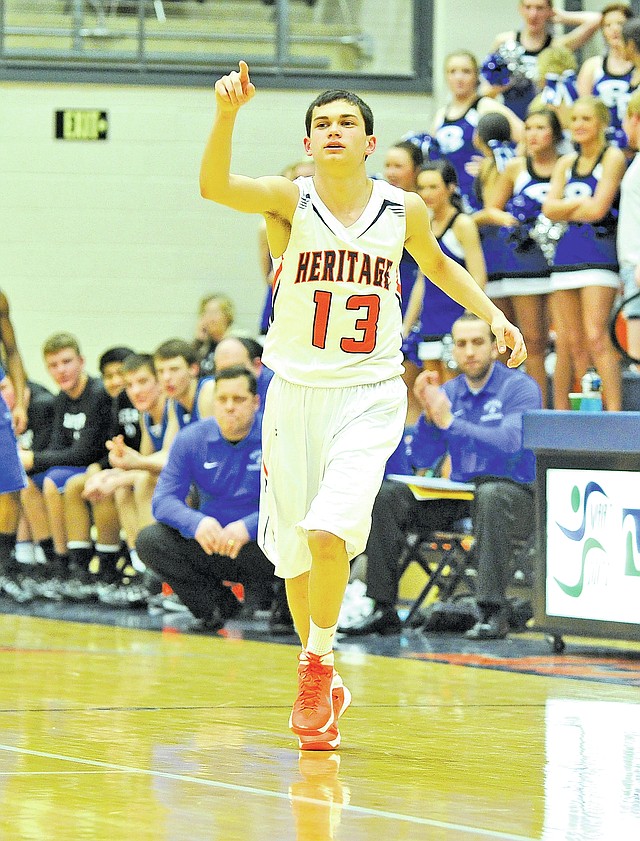  Staff Photo Michael Woods @NWAMICHAELW
MacKenzie Sams, Rogers Heritage guard, checks into the game Feb. 25 against Rogers High at Heritage.