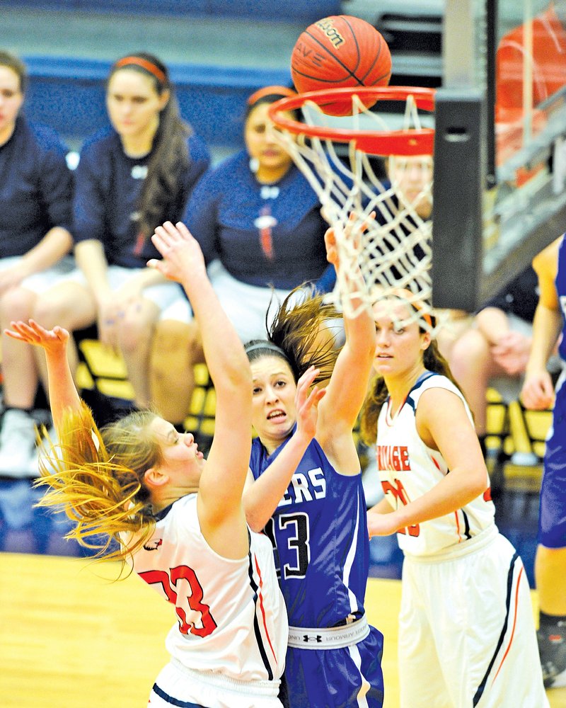  Staff Photo Michael Woods @NWAMICHAELW
Tasha Repella, Rogers High guard, drives past Rogers Heritage defenders to score a basket during the Feb. 25 game at Rogers Heritage.