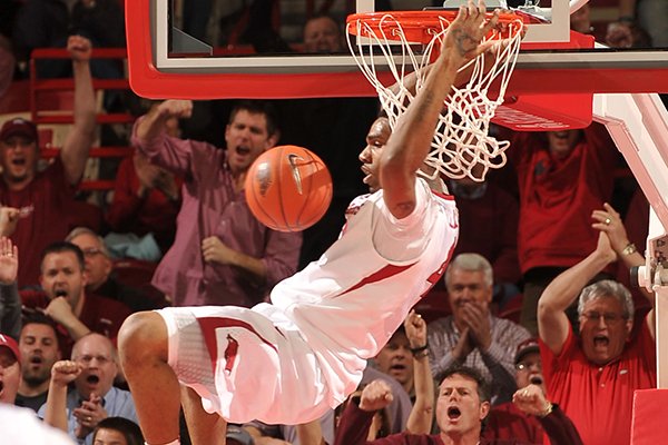 Arkansas forward Coty Clarke dunks the ball on a fast break during a 2014 game against Ole Miss at Bud Walton Arena in Fayetteville.