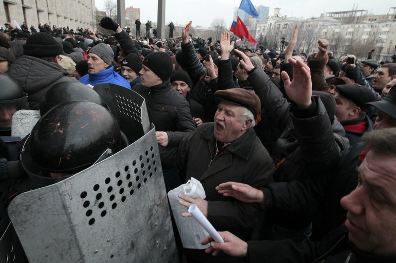 Demonstrators break police ranks smashing their way into the regional administrative building in Donetsk, Ukraine, on Wednesday, March 5, 2014. Hundreds of demonstrators waving Russian flags have stormed a government building in Donetsk in the eastern Ukraine. The region is the home area of fugitive Ukrainian President Viktor Yanukovych, who fled the country after protests in Kiev. 