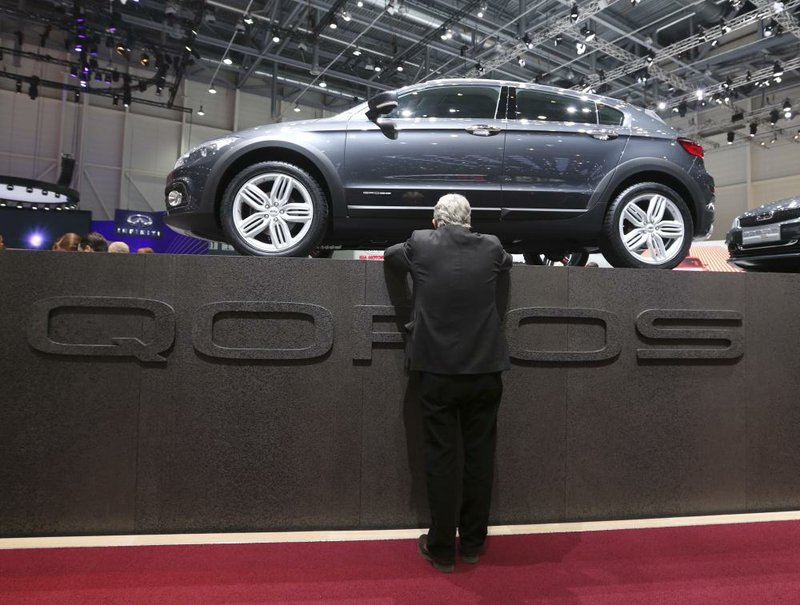 A visitor looks at the Qoros 3, produced by Qoros Auto Co., on Wednesday, the second day of the 83rd Geneva International Motor Show in Switzerland. The 3 is the second vehicle produced by the Chinese carmaker, which aims to expand its European presence. 