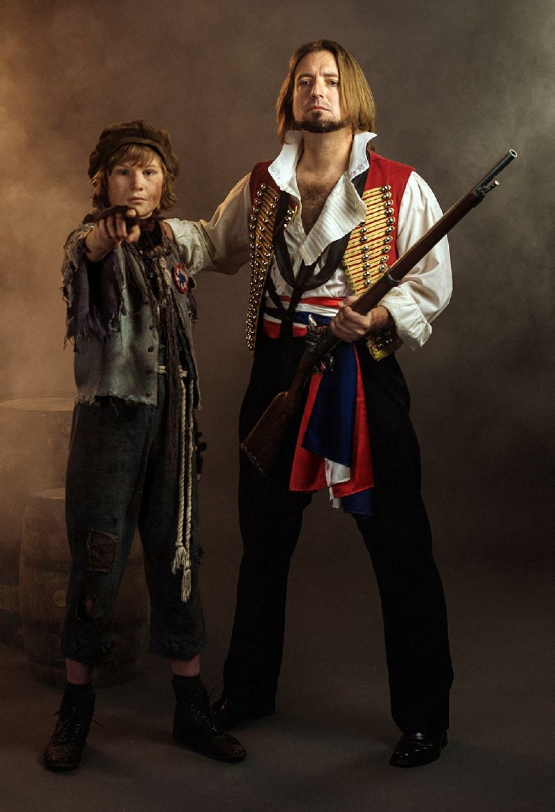 Gavroche (Matthew Hugg, left), and Enjolras (Caleb Reese) prepare for revolution in Arkansas Repertory Theatre’s production of Les Miserables. 